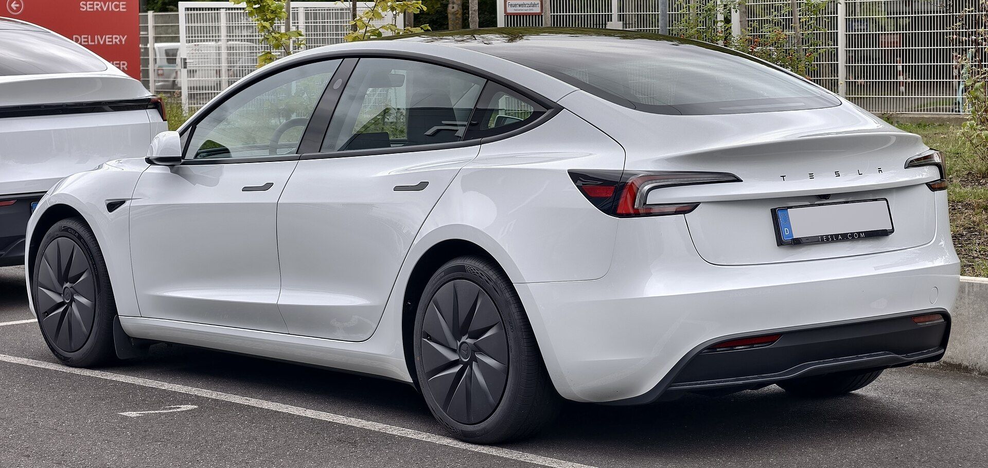 Beyaz Tesla Model 3 (Highland), arka çapraz görünüm